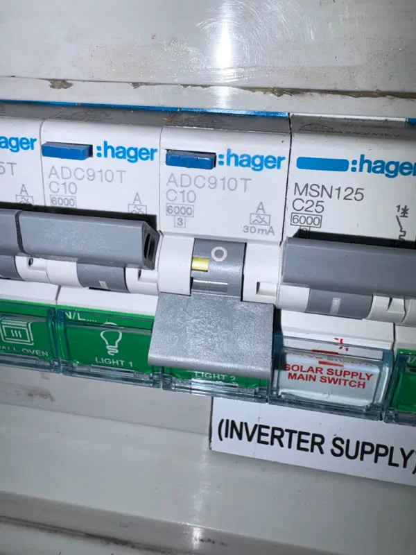 Close-up of Hager ADC910T RCBOs and a solar supply main switch on a switchboard