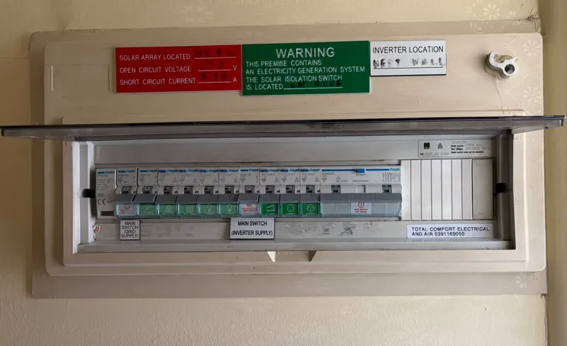 Hager switchboard with surge protection and RCBOs, with a printed Total Comfort Electrical and Air label