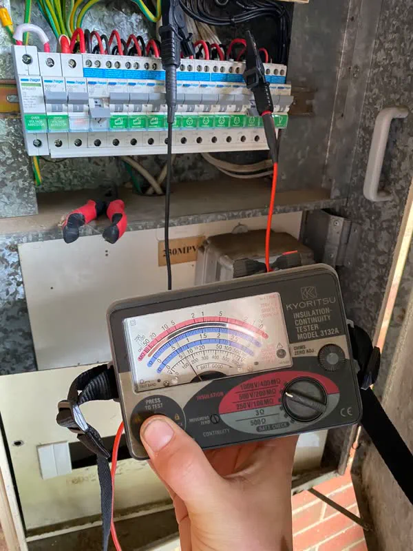 Kyoritsu insulation and continuity tester connected to a switchboard during an electrical safety check