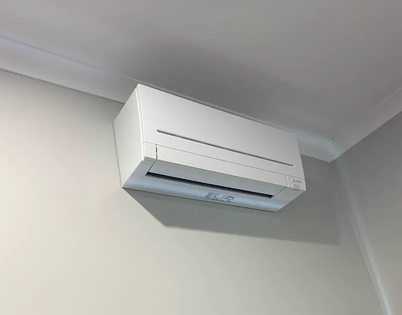 Mitsubishi Electric wall split mounted under the cornice in the corner of a room