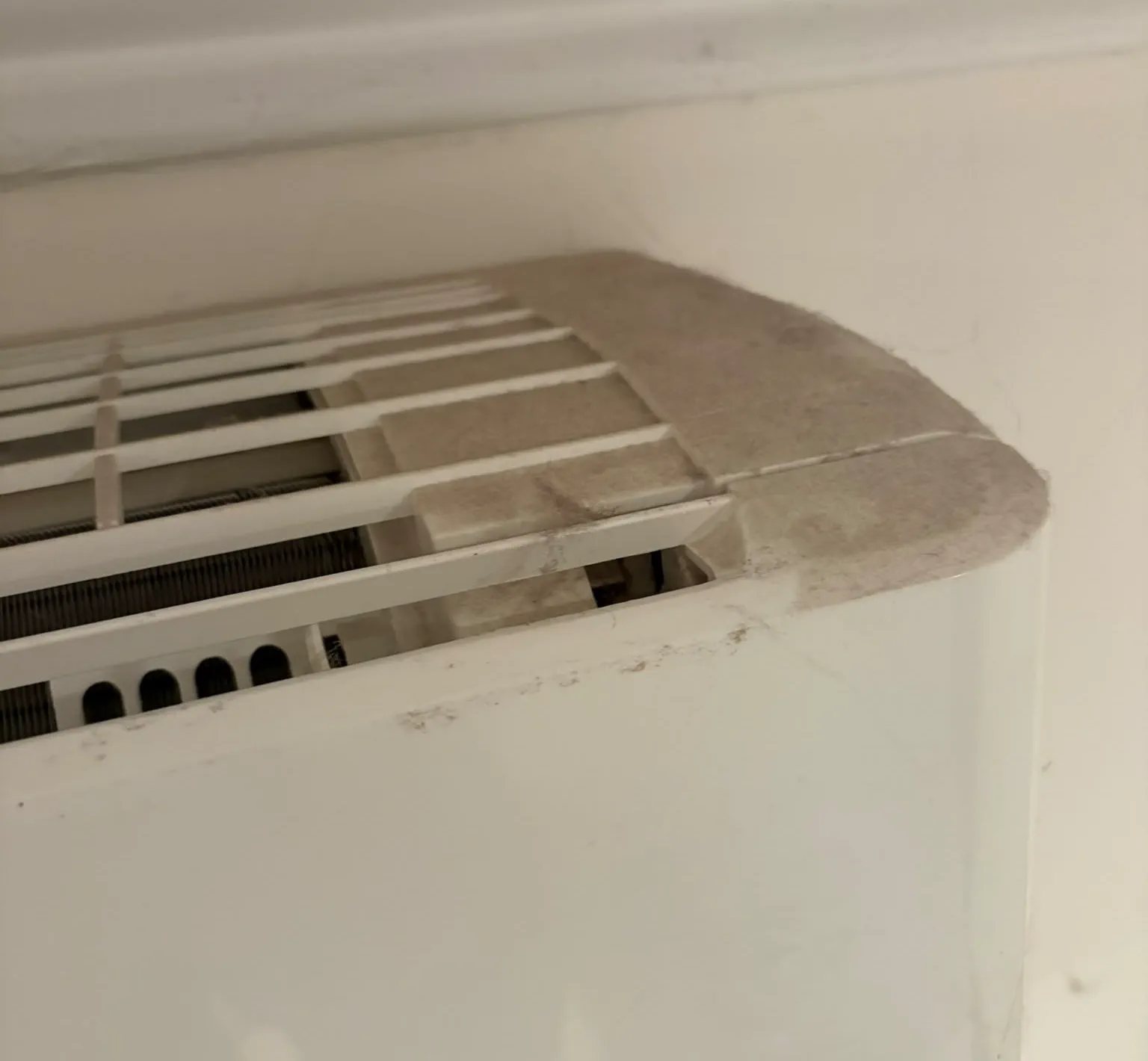 Dust and lint built up on the intake grille of a wall split